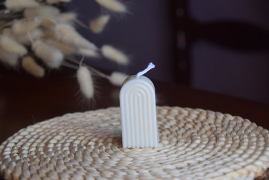 Vela decorativa mini arco con pabilo de algodon en fondo rustico.